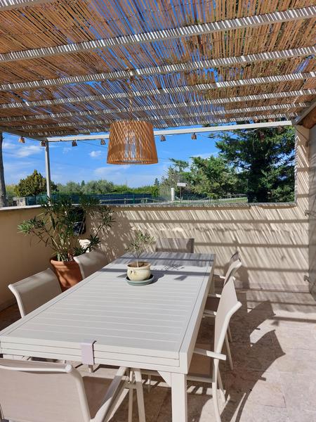 Schattige Terrasse mit Esstisch im Freien und Blick auf die Landschaft im Mas d’Anaé im Luberon